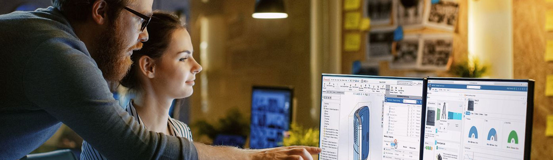 A picture of two people collaborating on a project on a computer