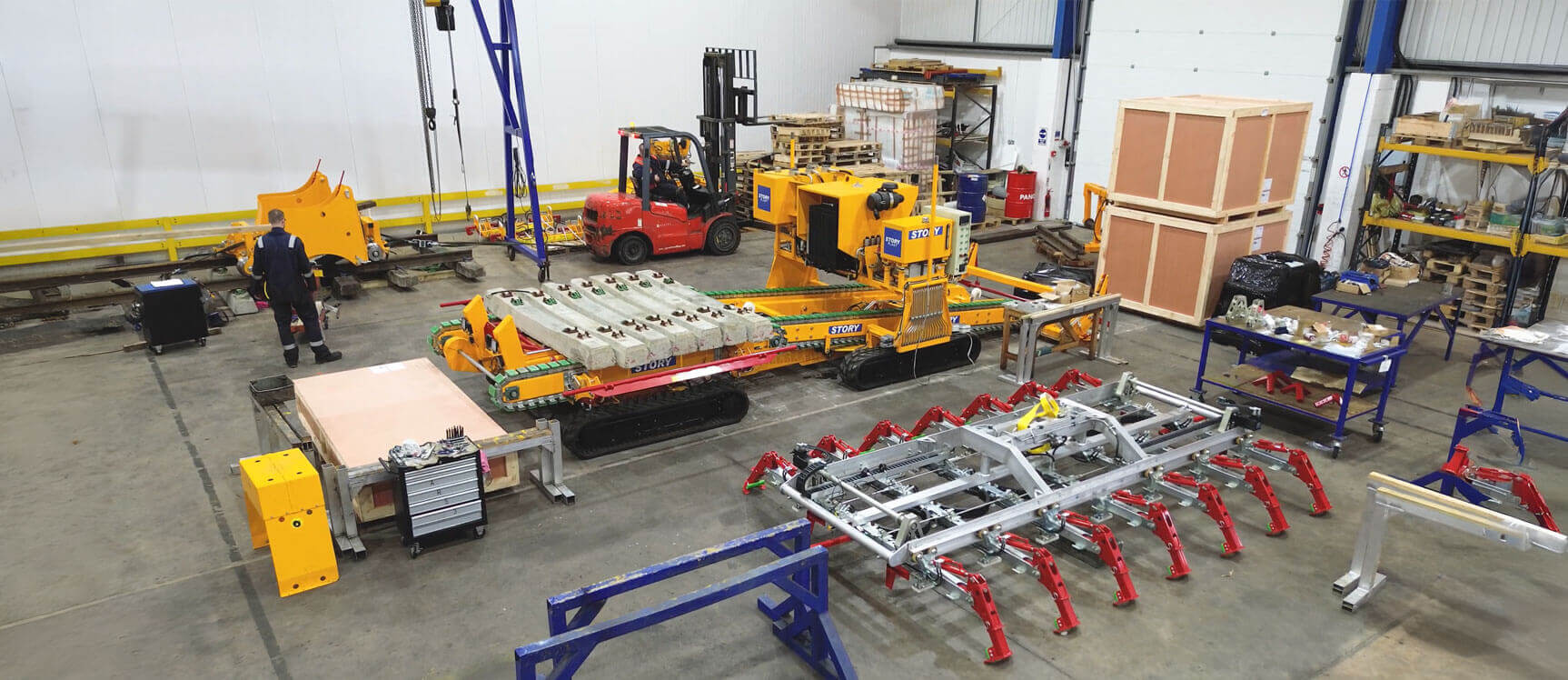 A photo of a Frangus railway sleeper layer in a factory.