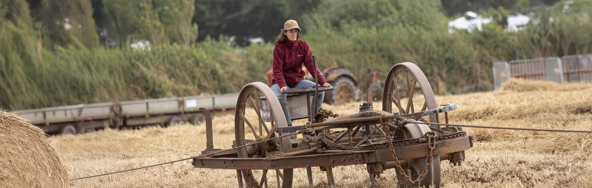 A photo of the Founder of Gradely Engineering, Lilly Day, with an old piece of machinery