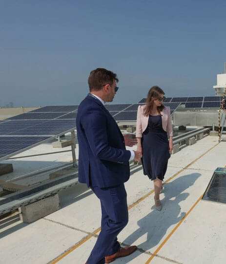 Two people looking at solar panels - SolarSub