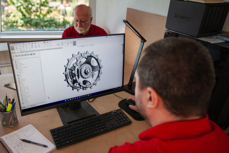 A member of the Wraith Group team working on SOLIDWORKS running on a computer